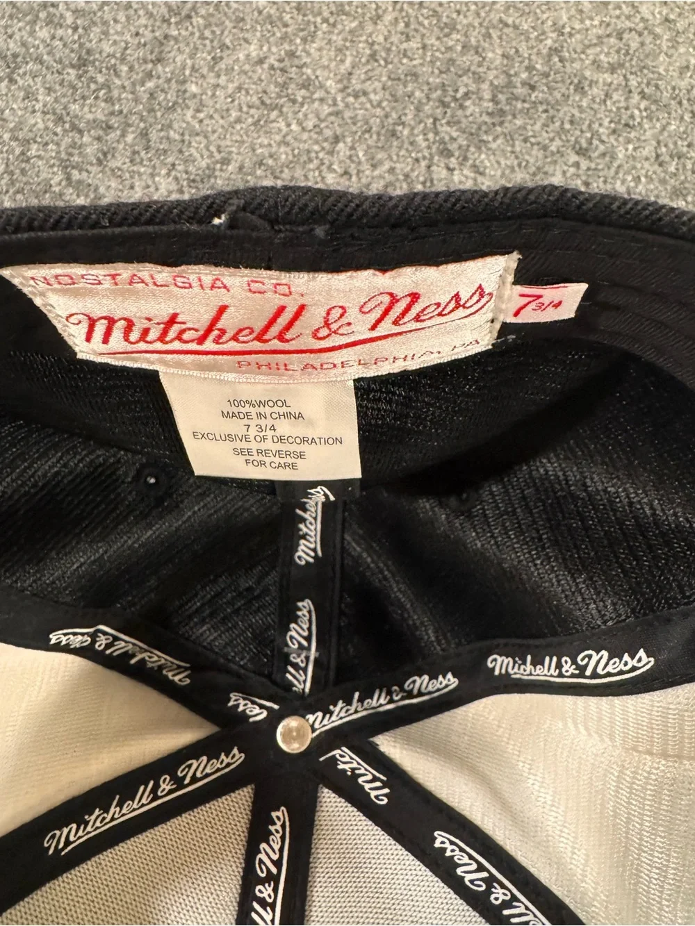 7 3/4 Mitchell & Ness Black and White with Satin sides.
